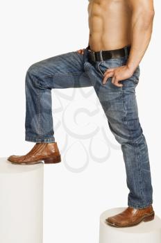 Man in jeans climbing up steps