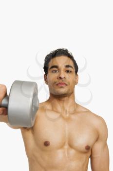 Portrait of a man exercising with a dumbbell