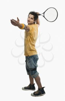 Man preparing to swing a tennis racket