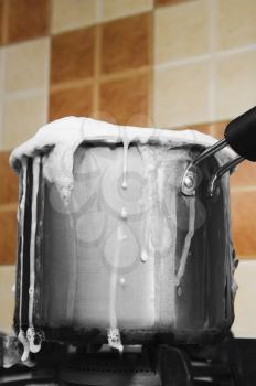 Milk boiling over a pan