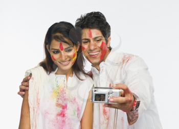 Couple taking a picture of themselves on Holi