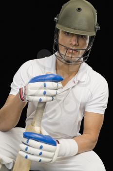 Portrait of a cricket batsman with a cricket bat