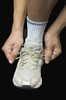 Athlete tying his shoelaces