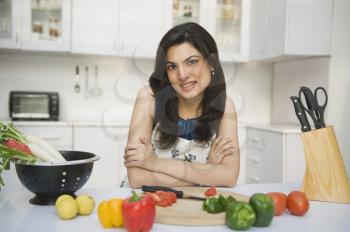 Portrait of a woman leaning on a kitchen counter