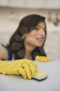 Woman cleaning a kitchen counter