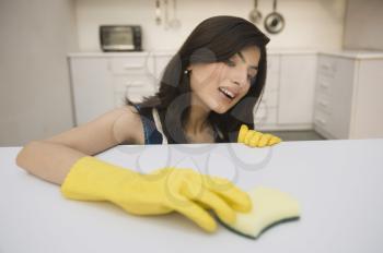 Woman cleaning a kitchen counter