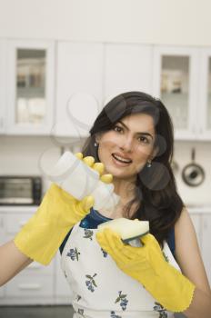 Woman pouring liquid soap on a sponge