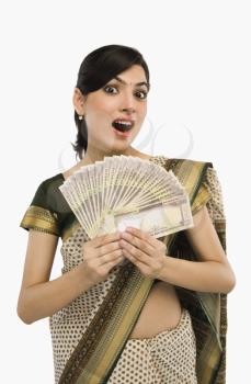 Woman holding currency notes