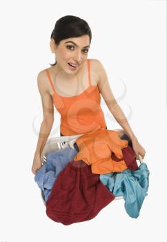 Woman holding laundry basket filled with clothing