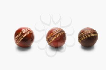 Close-up of old and new cricket balls in a row