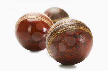 Close-up of old and new cricket balls