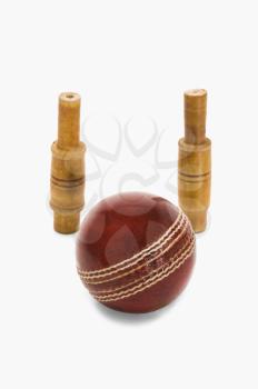 Close-up of a cricket ball and bails