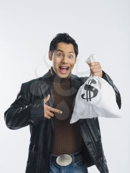 Portrait of a man holding a money bag