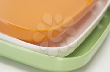 Close-up of a stack of colorful trays representing Indian flag colors