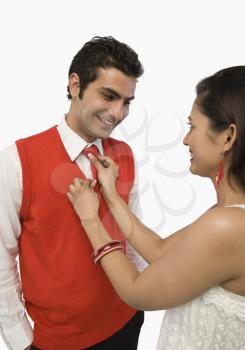 Woman adjusting her boyfriend's tie