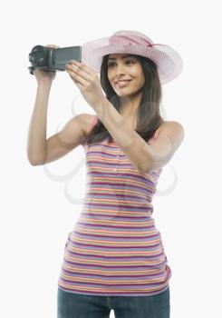 Close-up of a woman filming with a home video camera