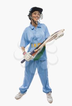 Close-up of a female cricketer holding a cricket bat