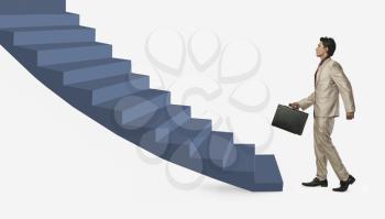 Businessman moving up staircase