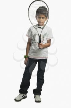Portrait of a boy holding a tennis racket