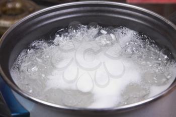 Close-up of rice boiling in a pan