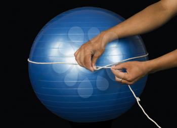 Close-up of a man measuring a curved surface with a string