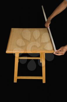 Man measuring a surface with a stick