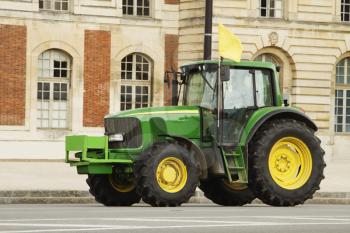 Tractor in front of a building, Paris, France