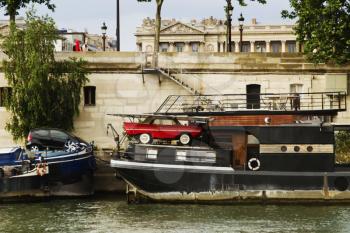 Cars being loaded on boats, Seine River, Paris, France