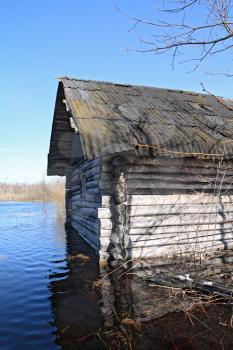 rural wooden house amongst spring flood