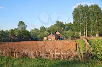 rural house near plow field