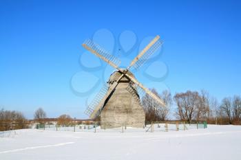 aging rural mill on snow field