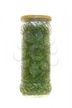 Tinned greens in a glass jar on a white background.                   