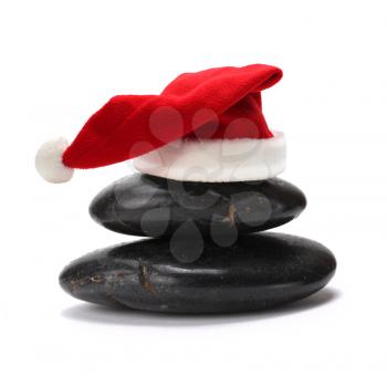 stack of stones with red santa claus hat