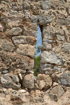 Small window in a fortress wall in Alanii

 