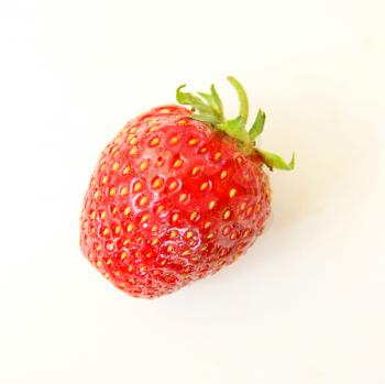One ripe berry of the strawberry on white background