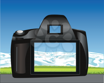 Camera takes pictures landscape with mountain and glade