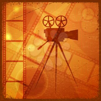 Vintage orange background with the silhouette of movie camera 