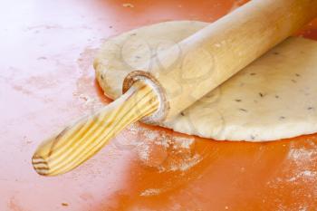 Royalty Free Photo of a Rolling Pin on Dough with Spices