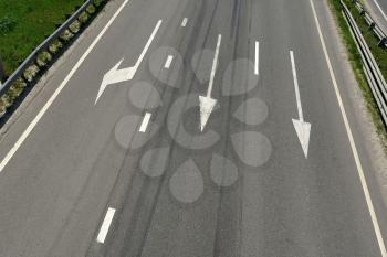 Highway with arrows marking on a sunny day, view from above from the bridge