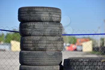 Old used and dirty tires, warehouse, stacked upright