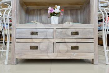 Beautiful Cabinet with drawers and flowers close up