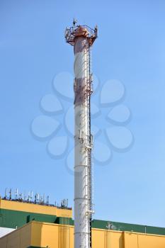 Antennas for cellular telephone communication on a large chimney.