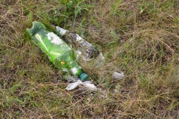 Abandoned plastic and glass bottle on nature, pollution of nature.
