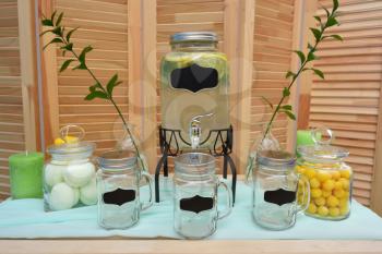 Lemonade bar on the background of wooden wall with dragee and marshmallow