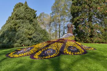Statue of erysimum flowers in the form of a firebird in a beautiful garden in Europe