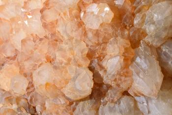 Gemstone Artichoke quartz and its texture, transparent, with an orange tint.