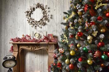 Christmas interior in brown tones with a Christmas tree, gifts, a wooden fireplace and a clock on a tripod
