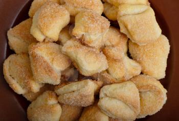 Fresh crispy cottage cheese cookies lies on a brown plate