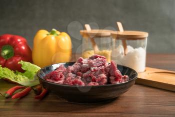 Raw beef with wooden table background, still life photography.