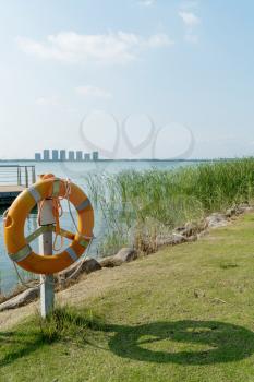 The life buoy by the lake in a public park. Photo in Suzhou, China.